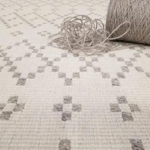 imaginative motif: the diamond pattern of a skyline wool rug or carpet (color ivory grey)