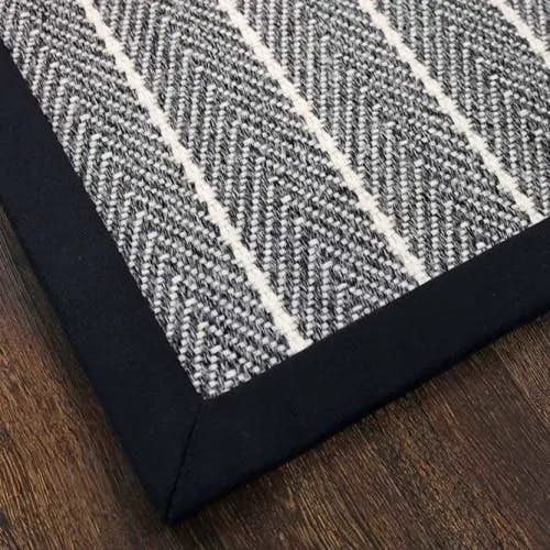 Bayside Black wool rug with cloth border and mitered corners