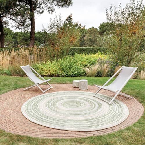 retreat: an outdoor levante rug in color mystic green sets the scene