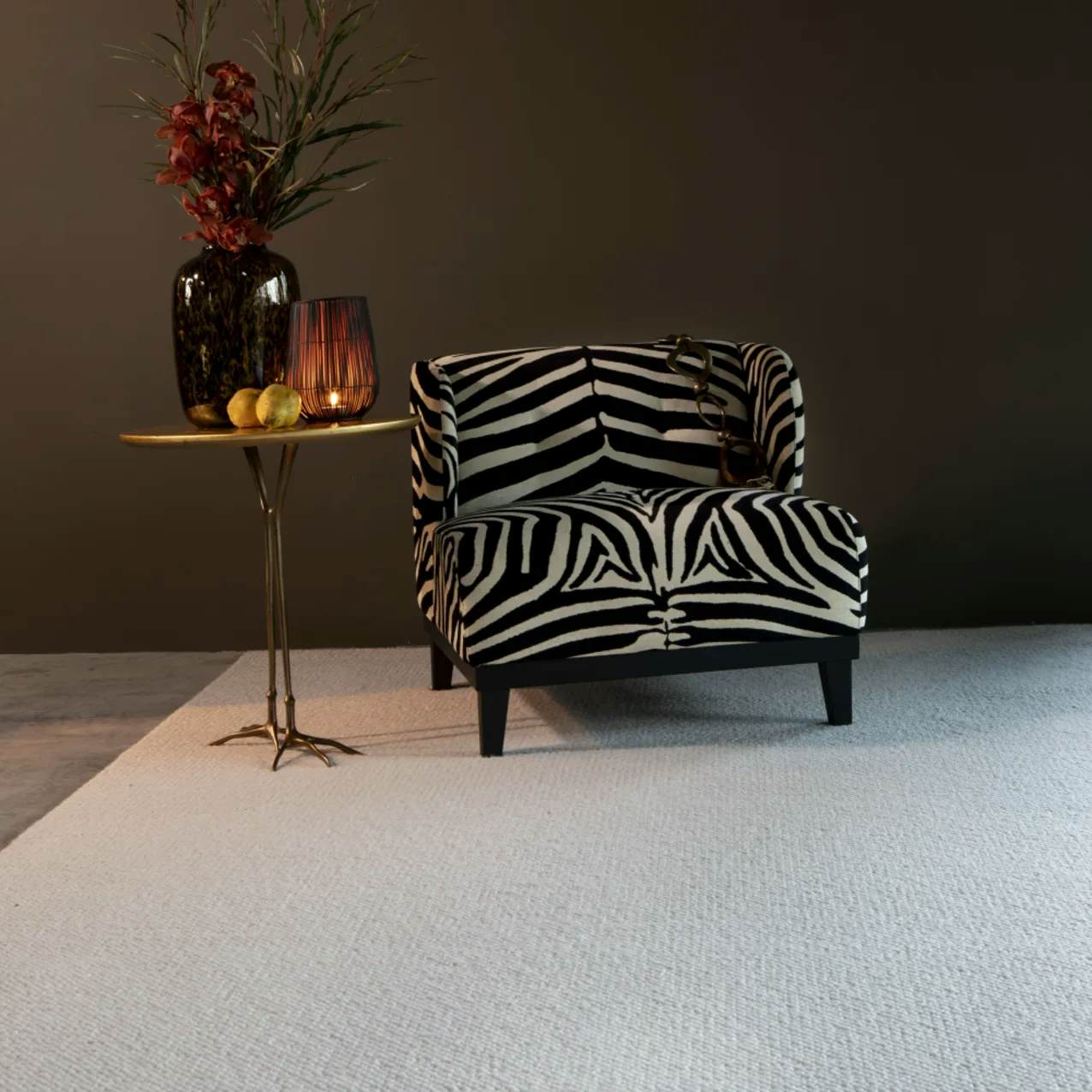 Knot My Style Ivory wool rug in room with zebra print lounge chair