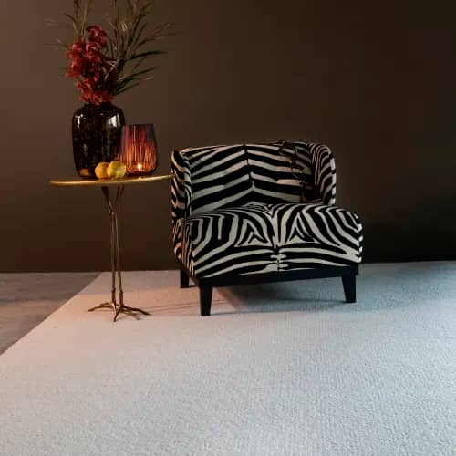 Knot My Style Ivory wool rug in room with zebra print lounge chair